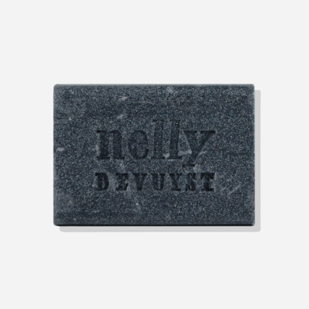 Nelly De Vuyst Exfoliating Body Bar, featuring organic ingredients like bamboo micro-granules and activated charcoal, displayed on a clean, minimalistic background.