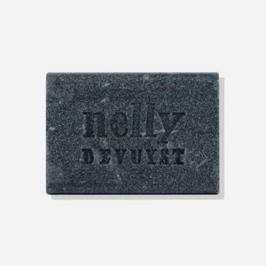 Nelly De Vuyst Exfoliating Body Bar, featuring organic ingredients like bamboo micro-granules and activated charcoal, displayed on a clean, minimalistic background.