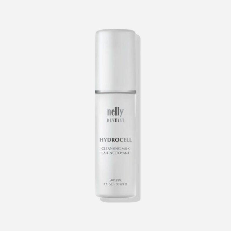 Bottle of Hydrocell Cleansing Milk with a soft, creamy texture, surrounded by natural ingredients like essential oils, showcasing its hydrating and nourishing properties for dry and sensitive skin.